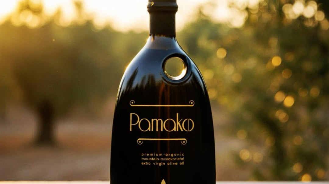 Elegant murrano bottle of Pamako high-phenolic certified organic olive oil. New harvest available at The Bio Foods.