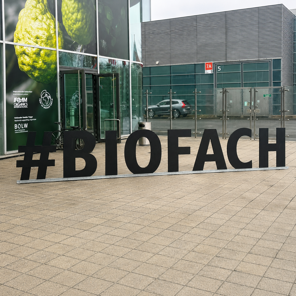 Large BIOFACH sign outside the entrance of a modern exhibition hall