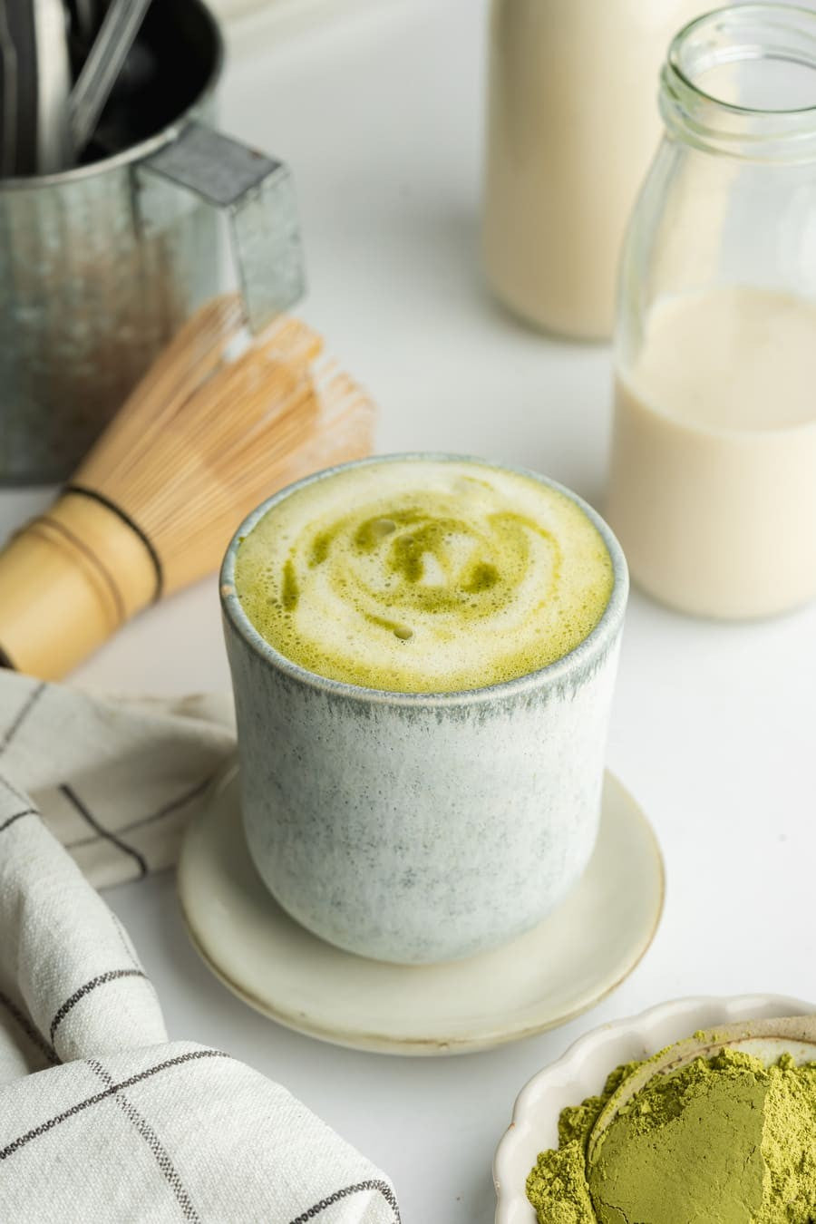 Whisked  organic matcha latte in a cup – natural energy boost and focus-enhancing superfood.